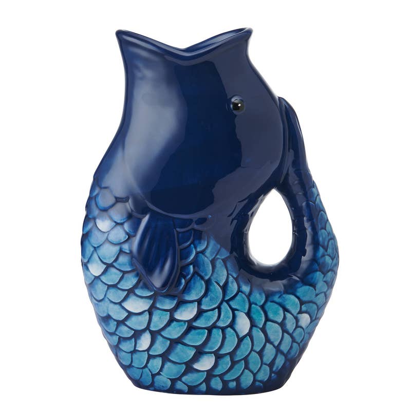 A Fitz and Floyd brand glossy ceramic fish-shaped pitcher or vase in deep navy blue with a scaled blue and turquoise pattern on the lower half, shown on a plain white background.