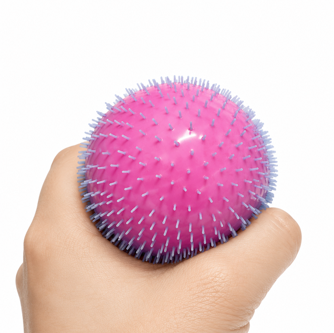 hand squeezing pink textured ball on white background