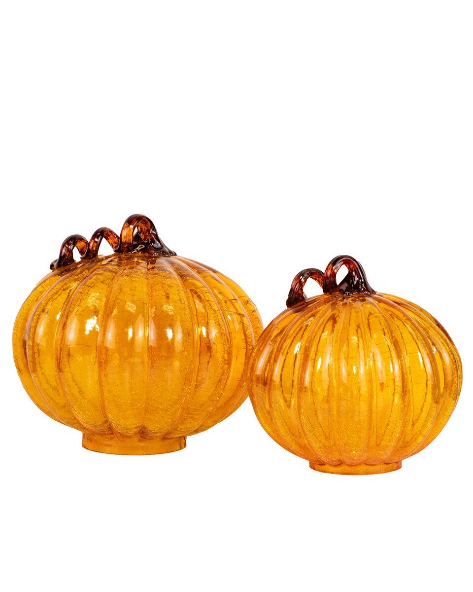 Two orange glass pumpkins with ribbed texture on a white background