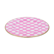 Round pink and white checkered plate with a gold rim on a white background