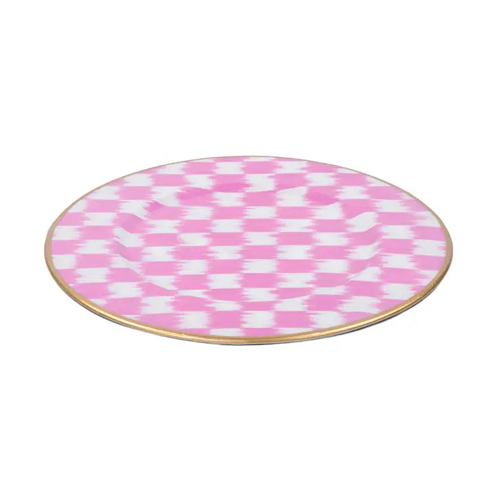Round pink and white checkered plate with a gold rim on a white background