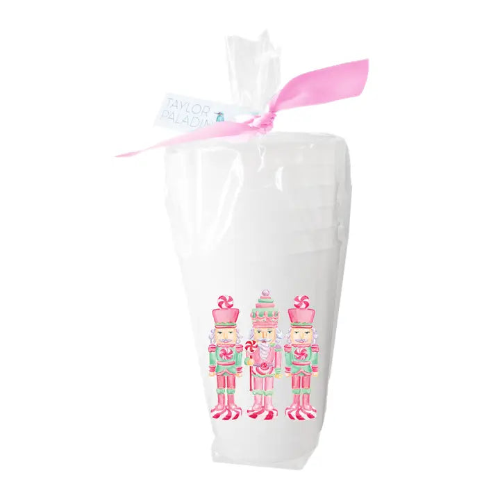 White bag with pink ribbon and nutcracker design on cups  a white background