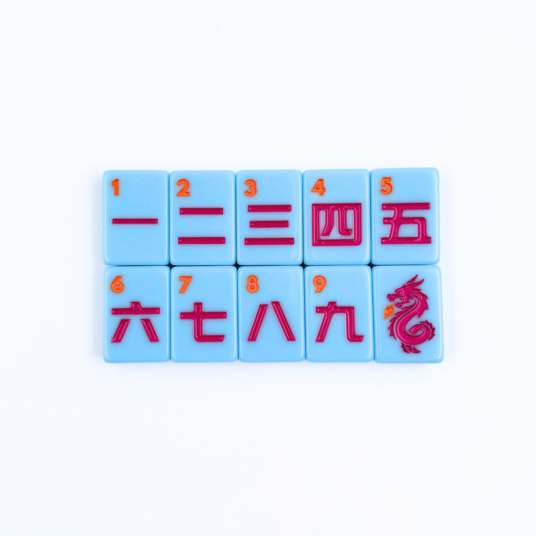 Set of blue mahjong tiles with red numbers and symbols on a white background