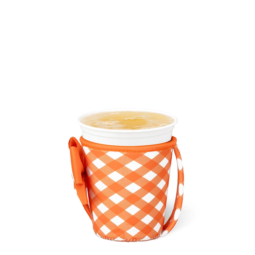 An orange and white gingham patterned insulated cup sleeve holding a white cup with a yellow beverage, set against a plain white background.