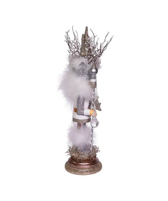 Decorative figure with white fur, silver accents, and branches on a white background