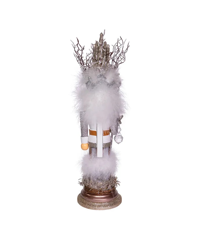 Decorative figure with white fur, antlers, and a crown on a white background