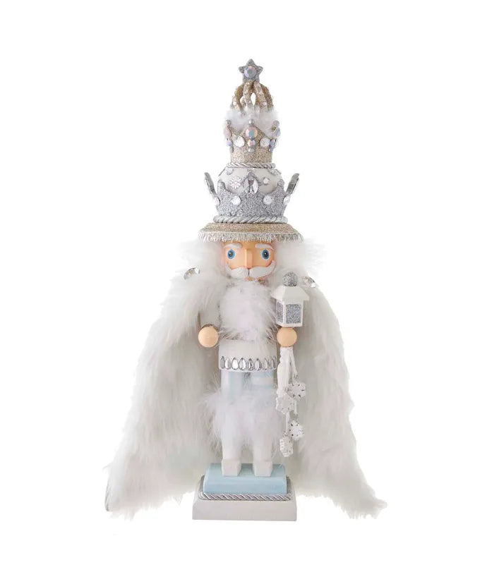 Decorative figure of a nutcracker with a silver crown and white outfit on a white background