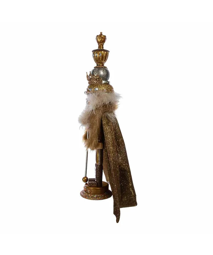 Decorative figure with gold robe, crown, and fur on a white background