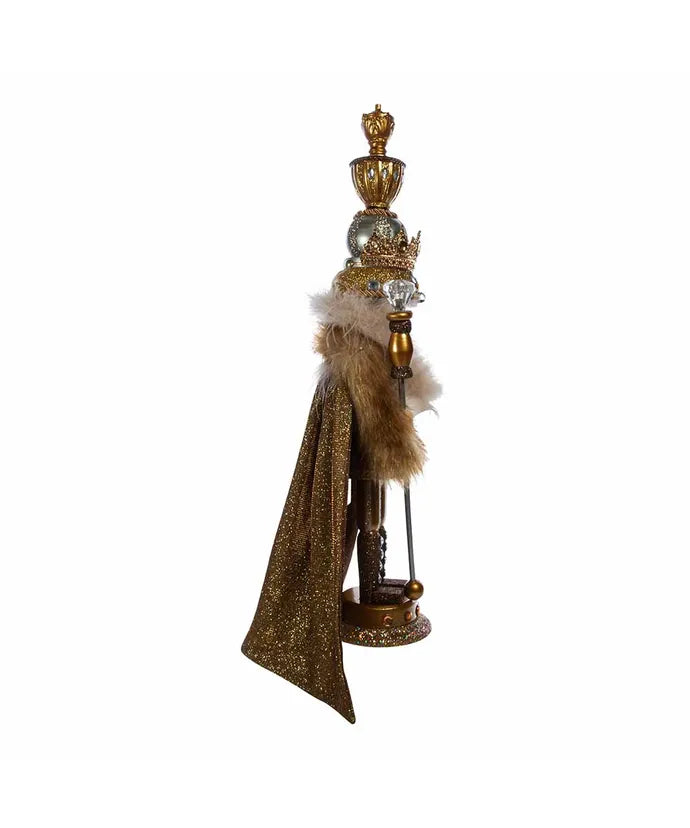 Decorative figure with a crown and cape on a white background