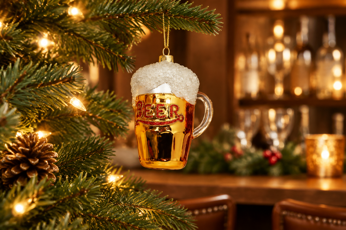 One Hundred 80 Degrees frothy beer mug ornament hanging on a decorated holiday tree in a home bar