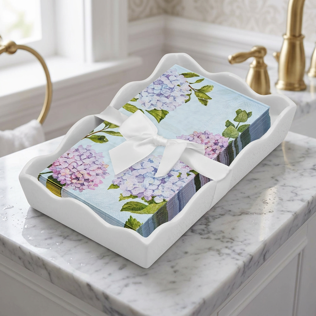Hydrangea paper napkins in a white ceramic tray on a marble powder-room vanity.