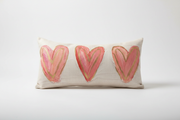 Southern Cotton Mill Decorative pillow with three pink hearts on a white background