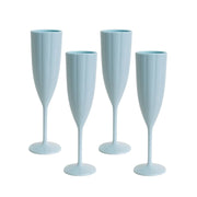 Four light blue champagne flutes on a white background