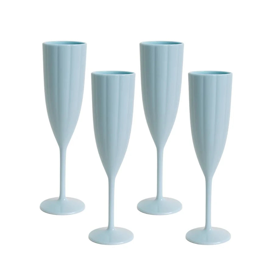 Four light blue champagne flutes on a white background