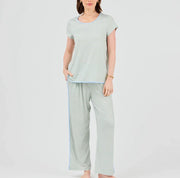 Woman wearing a striped t-shirt and pants on a white background