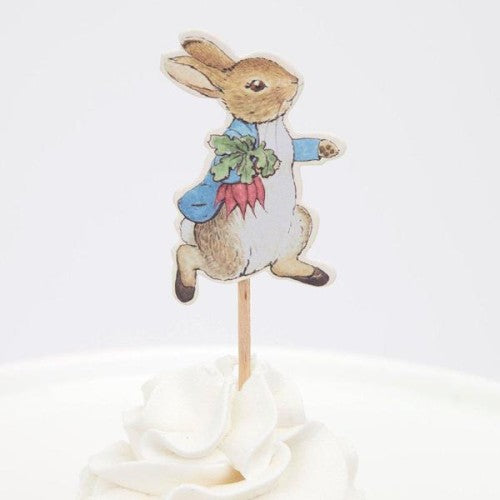 Cake topper with a rabbit character holding a radish on a white background