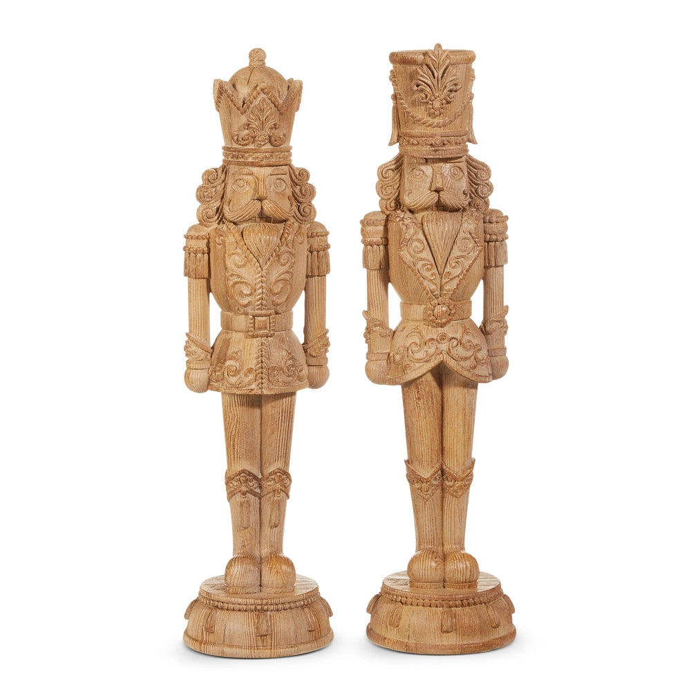 Two ornate wooden nutcrackers on a white background