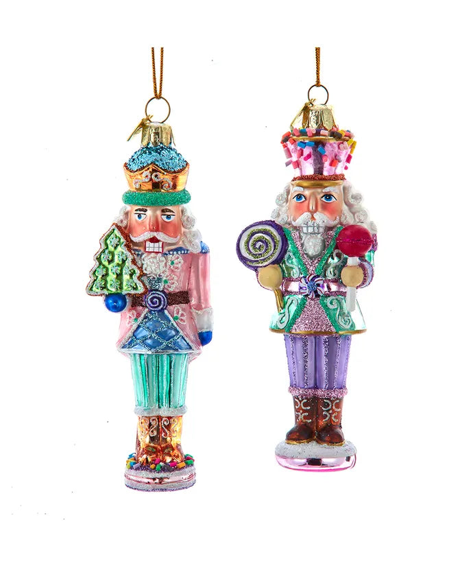 Two colorful glass nutcracker ornaments on a white background