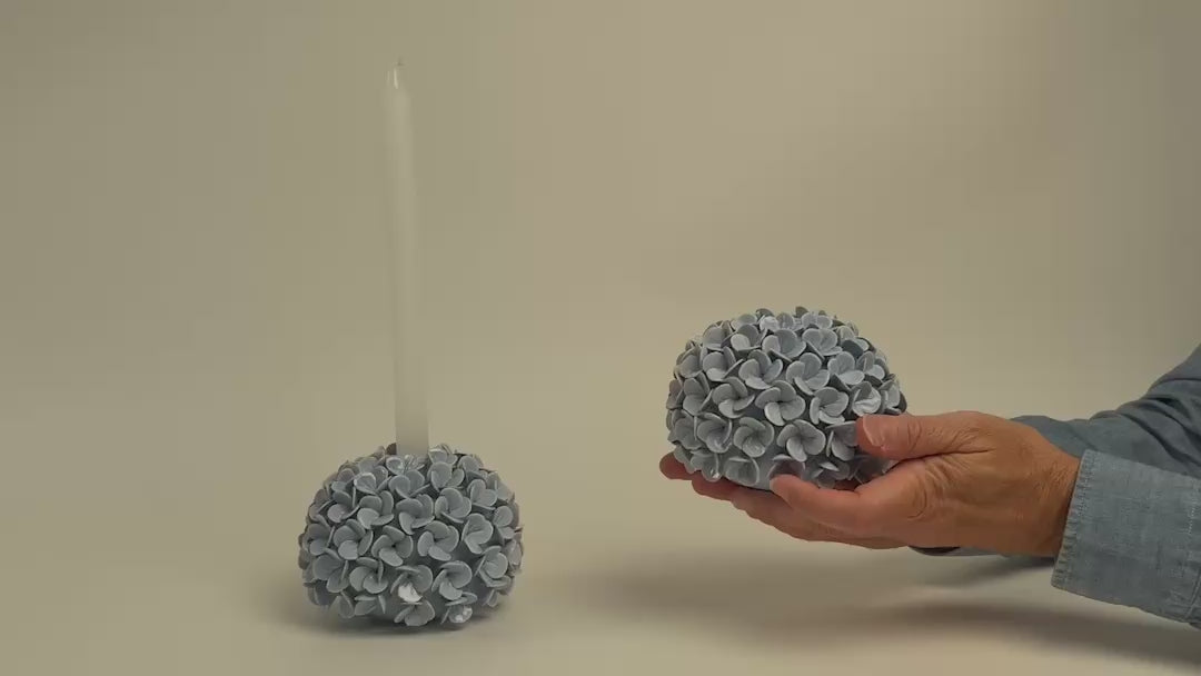 Load video: video of Two's Company brand round taper candle older or vase covered in small hydrangea shapes
