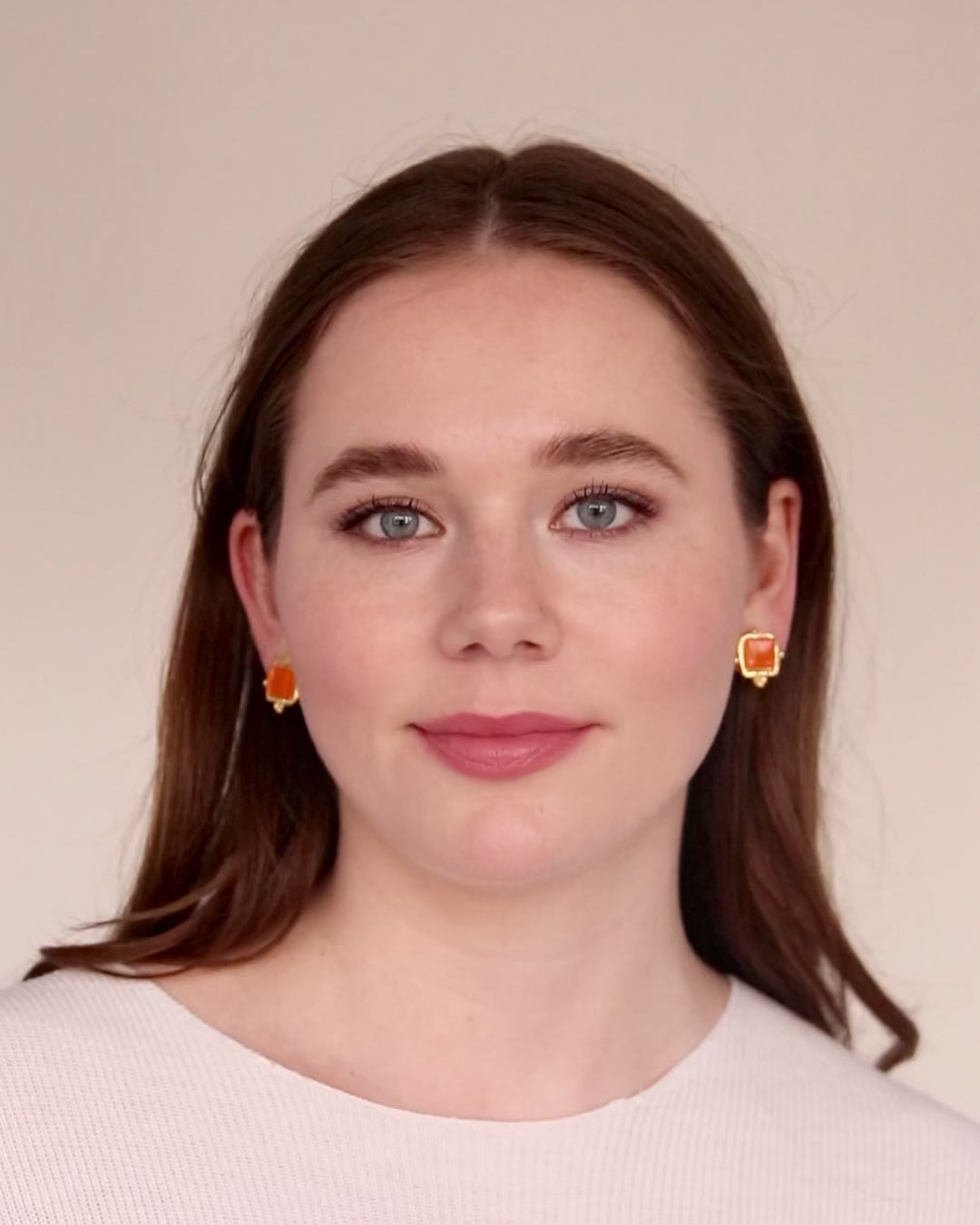 Load video: Video of woman wearing Chalotte style orange french glass Susan Shaw stud earrings