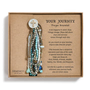 Prayer bracelet with beads and a cross on a brown card with text, Demdaco brand visible