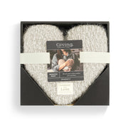 White plush blanket in a black box with 'Giving Collection' label on a white background