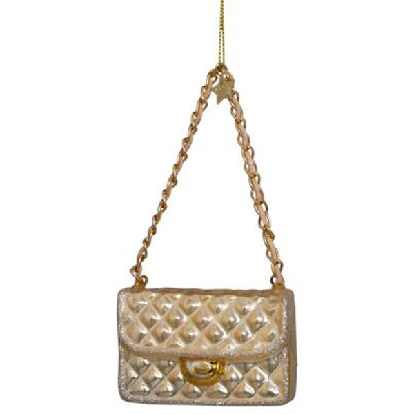 Decorative ornament shaped like a quilted handbag with a chain strap on a white background