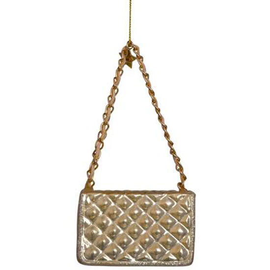 Decorative metallic gold handbag with chain strap on a white background