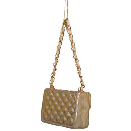 Gold handbag with chain strap on a white background