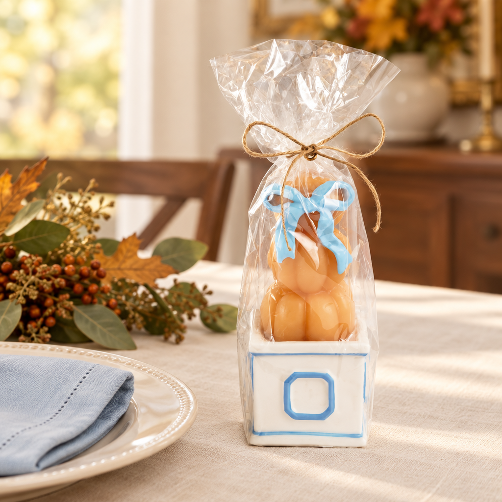 Wrapped pumpkin topiary candle styled as a Thanksgiving hostess gift