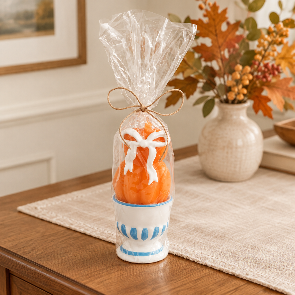 Wrapped two-pumpkin candle styled as an autumn gift